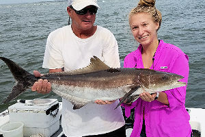 Pretty young lady angler holding nice Cobia with Capt. Scarborough.