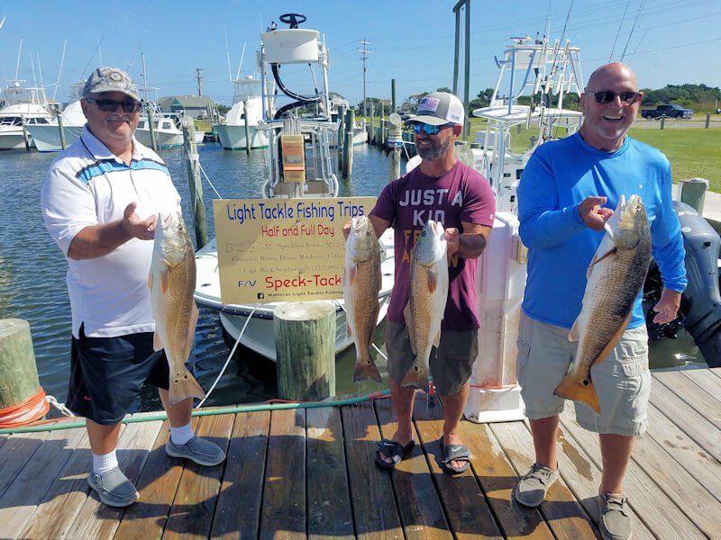 Bernar and Luke Shocklee and friend John (Skipper) show off their nice catch of Red Drum at the dock.