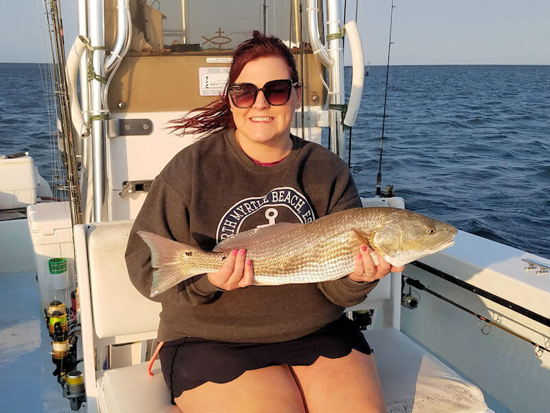 Jennifer from Winston Salem holds a large Red Drum caught in the Pamlico Sound.